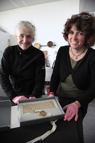 Antje Stubenrauch, restorer from the Archives of Lübeck, examines the Lübeck letter with Linda Ramsay, Head of Conservation at the National Record of Scotland, as it is returned to Scotland for an exhibition at the Scottish Parliament